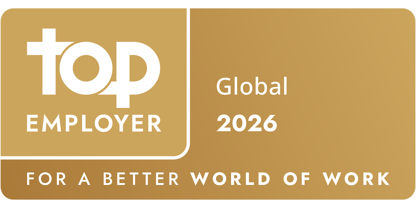 Gold plaque with Top Employer Global 2026 text, featuring a stylised top logo. Below, it reads For a Better World of Work. The background has a gradient of darker to lighter gold tones.