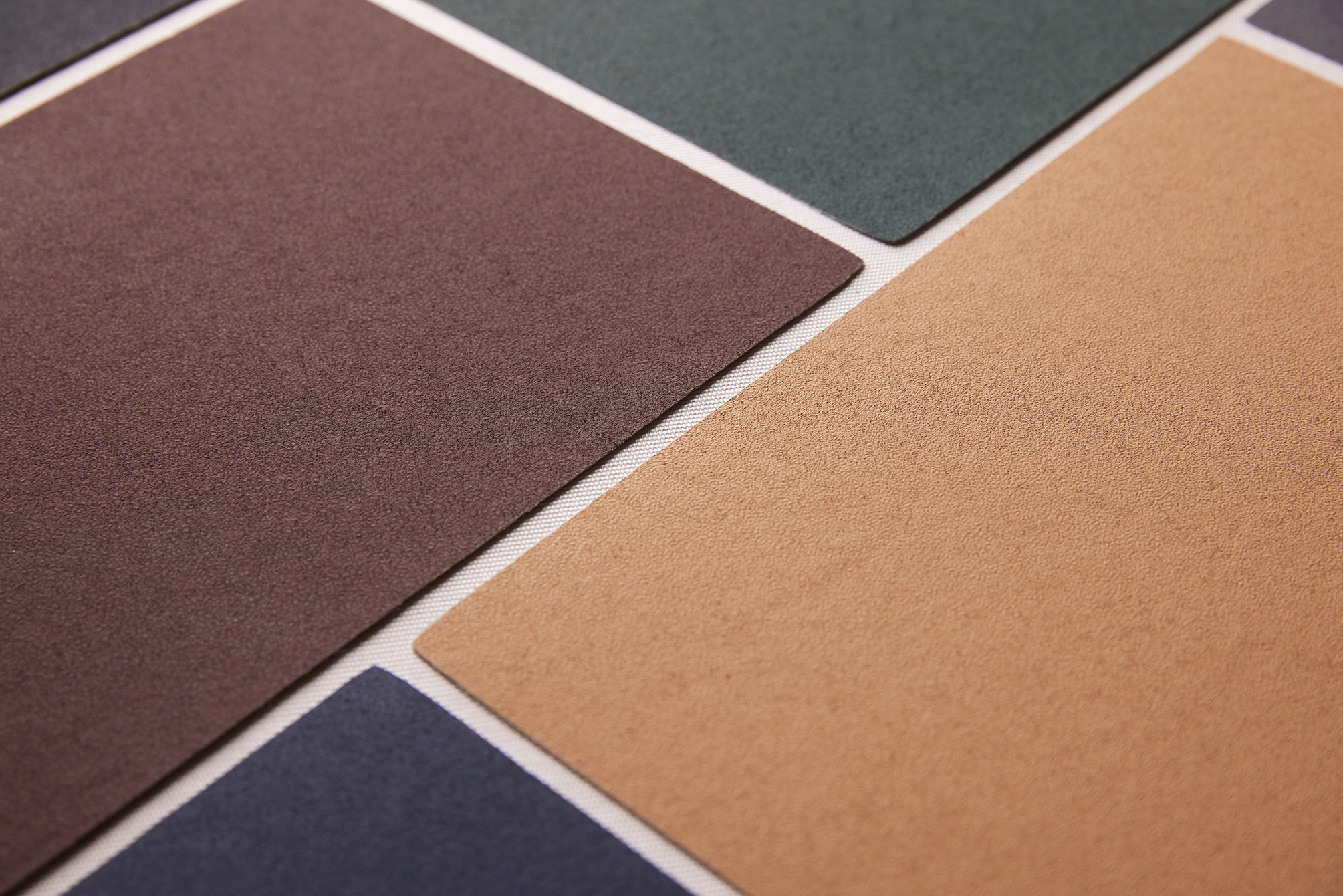 Close-up of rectangular acoustic panels in various earthy colours arranged in a geometric pattern.