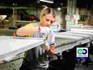 Female Ecophon co-worker inspecting an acoustic panel at the production line