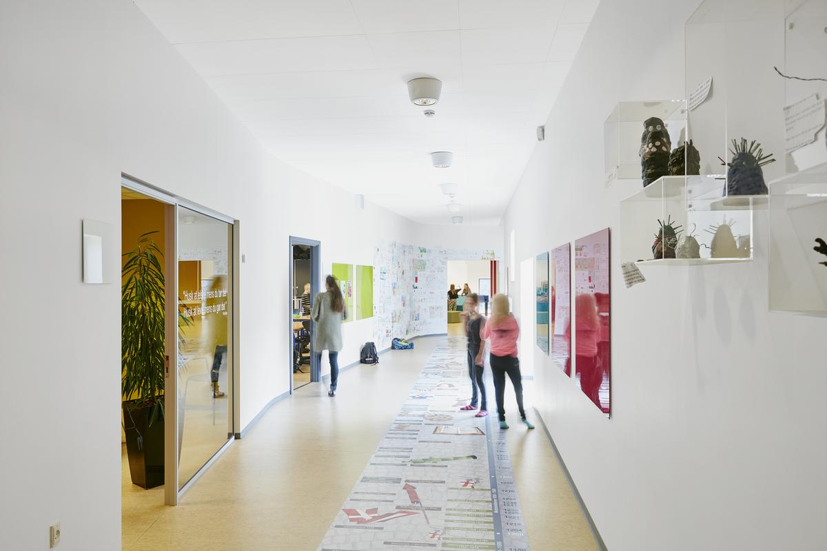 Pupils in school corridor with acoustic ceiling