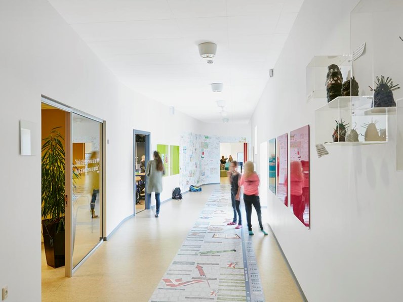 Pupils in school corridor with acoustic ceiling