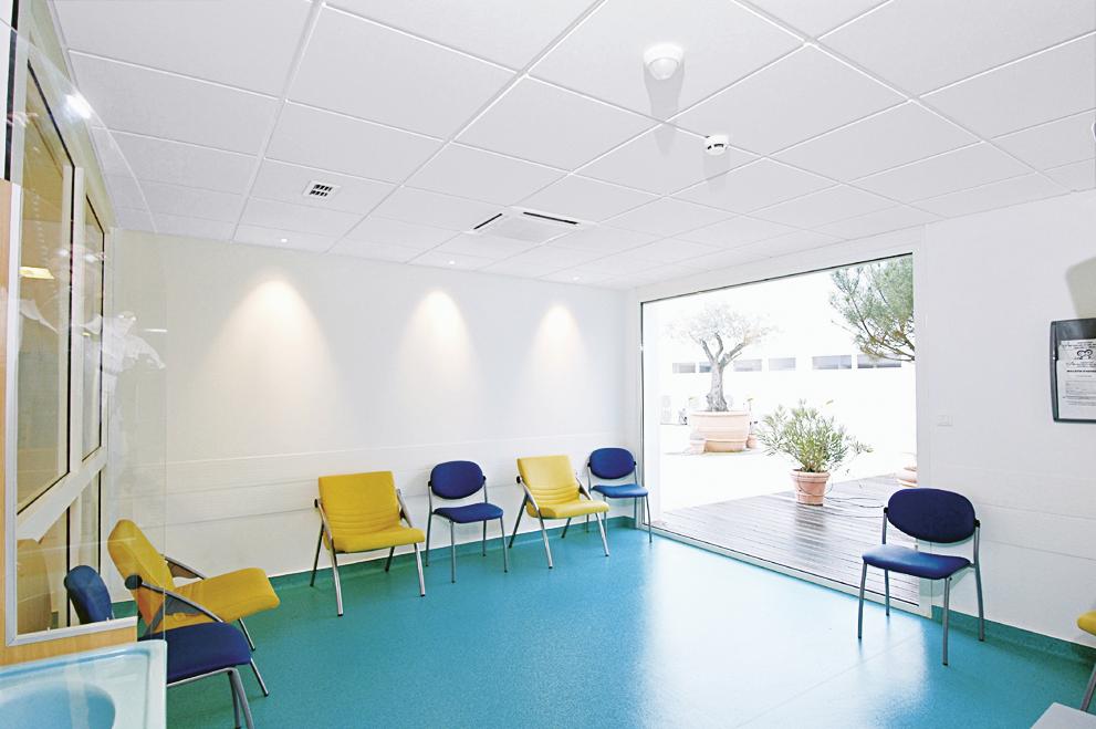 Empty hospital waiting area with acoustic ceiling