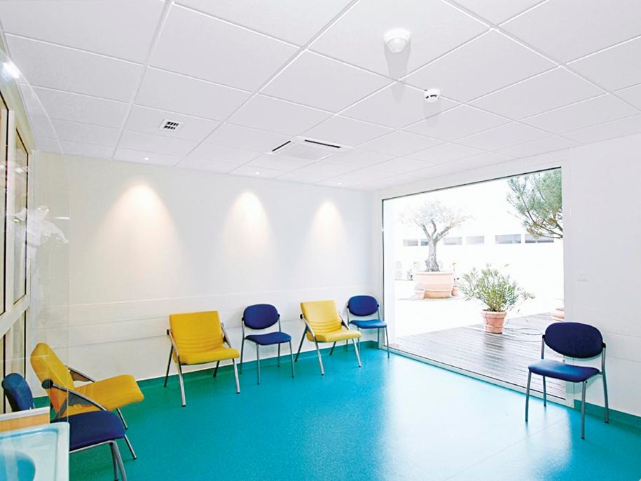 Empty hospital waiting area with acoustic ceiling