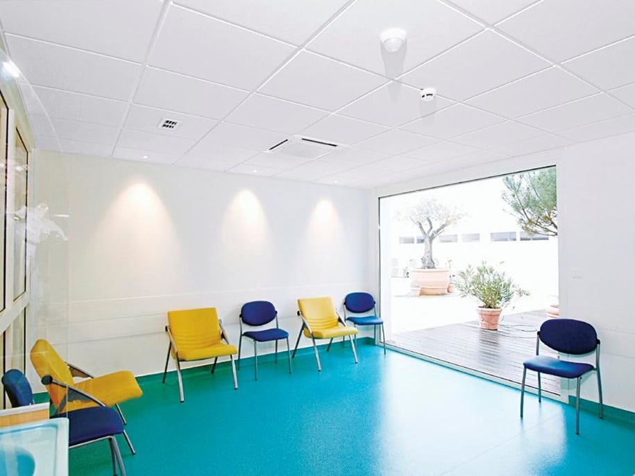 Empty hospital waiting area with acoustic ceiling