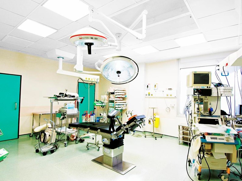 Empty operating theatre with acoustic ceiling and integrated lighting