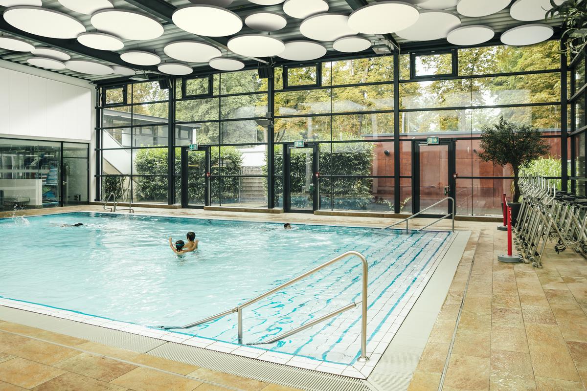 Swimming pool area with acoustic ceiling and acoustic wall panels