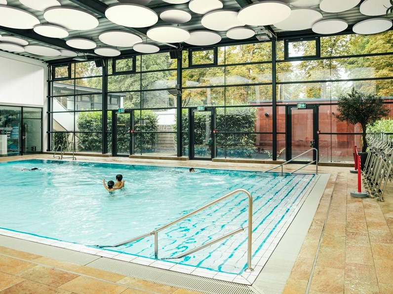 Swimming pool area with acoustic ceiling and acoustic wall panels