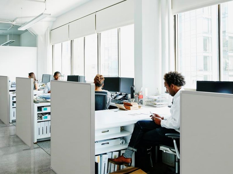 Open space office with work spaces divided by acoustic screens