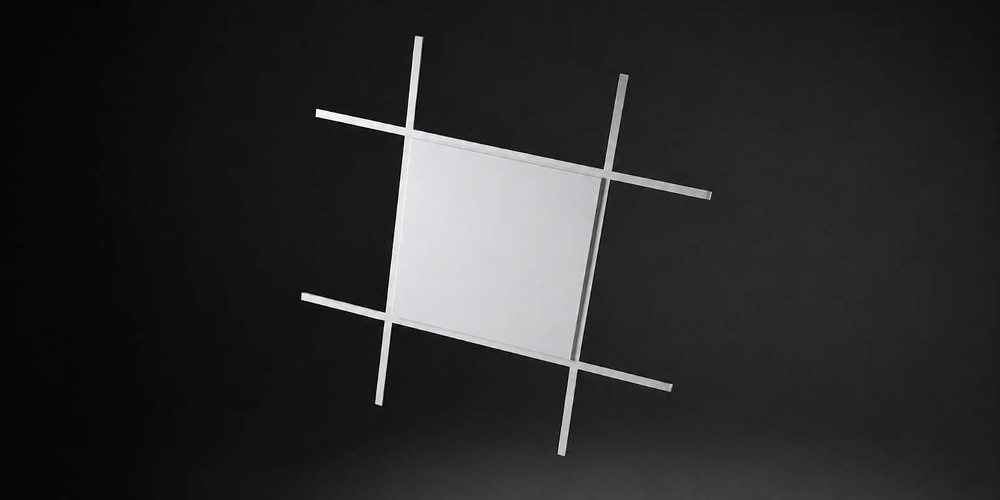 A white acoustic panel in a grid system on a black background. 